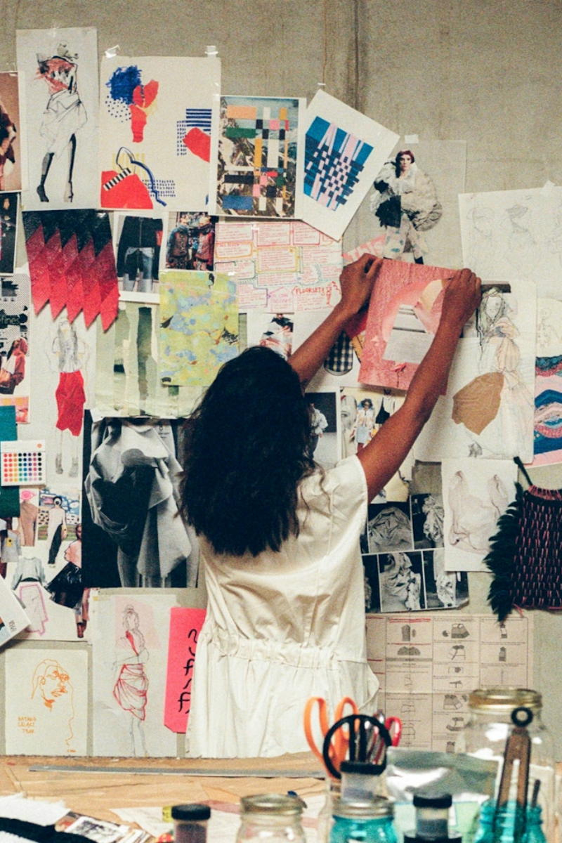 Untitled design (24) person putting images on to a wall
